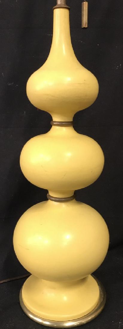 Yellow Toned Metal Lamp: Lamp is yellow toned & metal. Contains 3 bulb sockets & Metal finials. Measures approximately 32 inches tall 7 inches wide. Table lamp, home accent, home lighting, 6