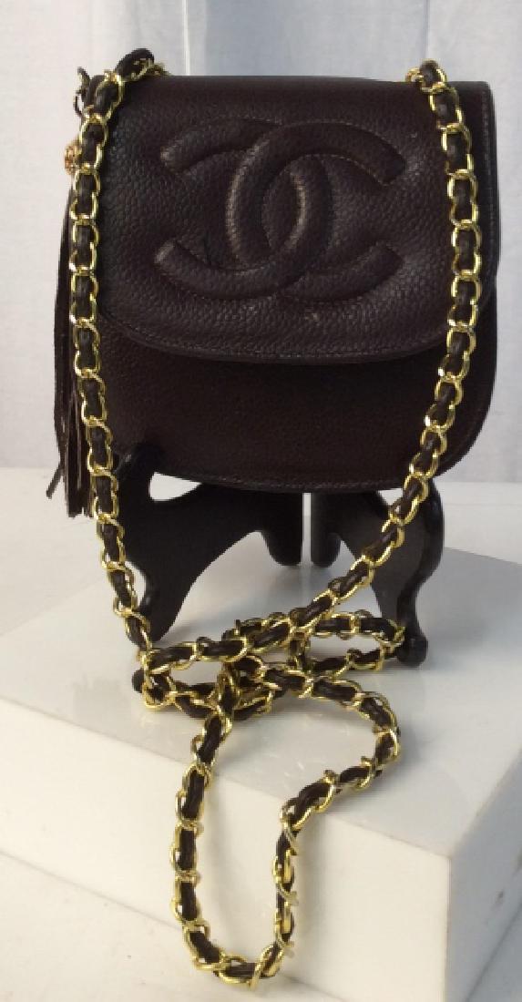 Authentic CHANEL Chain Shoulder Mini Bag: Vintage Chanel. Brown. Adorned with Tassel and Gold Tone Hardware. Reinforced Structure. Strap 21.5 in. in diameter. Approx 6 x 5.5. Possibly Needs Cleaning. With Lexington mini handbag tote. 8 x 5.5 