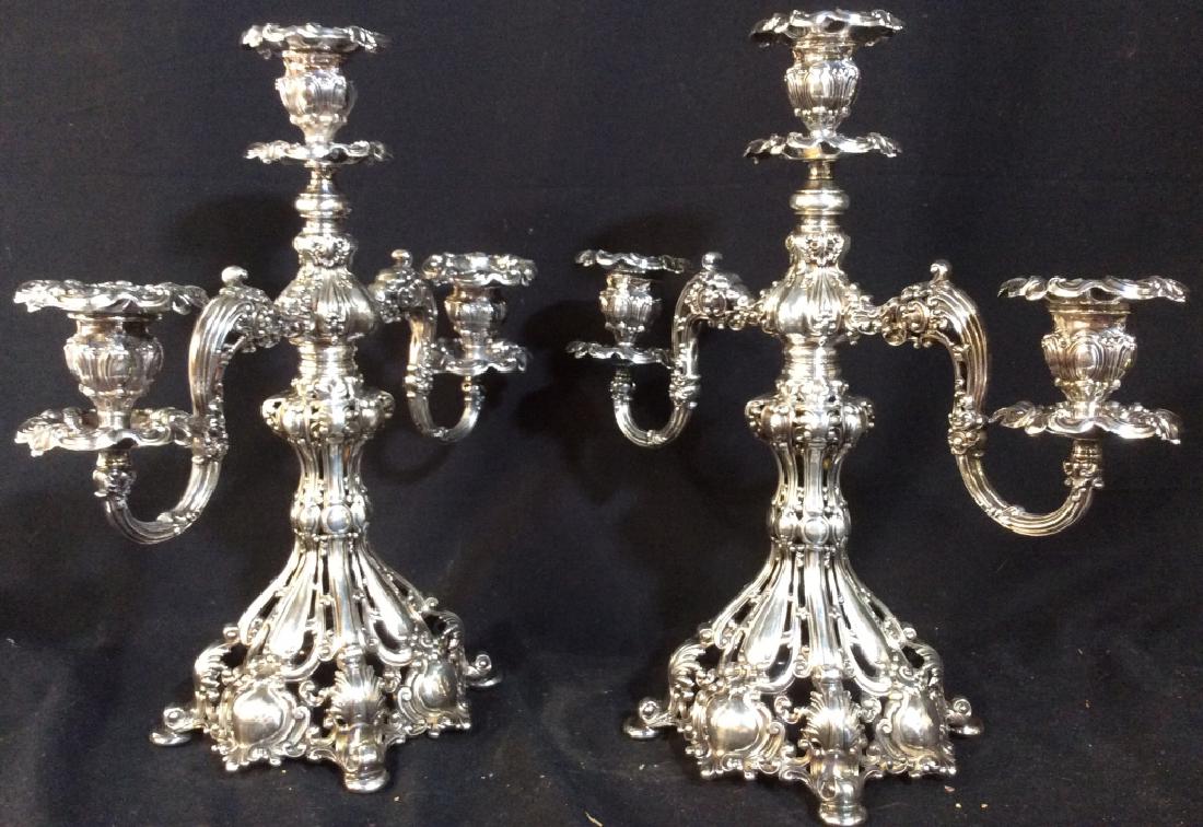 REED & BARTON Ornate Silver Toned Candelabras: Lot includes 2 candelabras each are marked REED & BARTON 800 ON Undersides. Appears to be part sterling silver. Each piece has 3 arms. Each measures approx 16 inches tall 15 inches wide 8 inches deep.