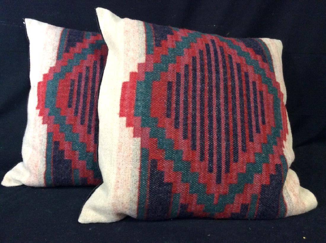 Pair Oversized Woven Throw Pillows: Toss pillows, home accent, home decor. Oversized measures approx 23 in by 23 in, possibly handcrafted, woven front panel with red green and blue geometric patterns against sand toned ground, black ton