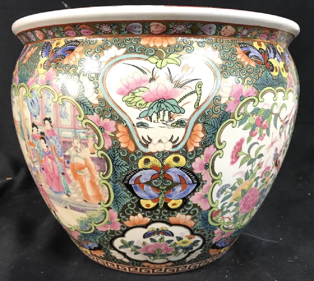 FAMILLE ROSE Asian Porcelain Flower Pot: Flower Pot has intricate detail including images of male and female figures, butterflies, flowers, leaves, and vines. Piece is signed on underside with Asian characters. Interior has images of fish. A