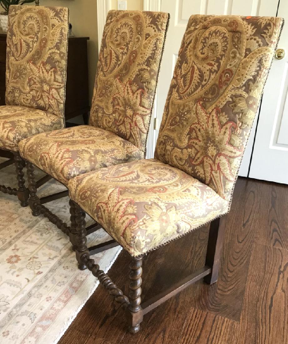 Lot 4 High Back Upholstered Dining Chairs: Dining chairs have twist wood front legs. Plush jacquard paisley patterned fabric upholstery with metal tack detailing. Measures approx 43.5 inches in height by 20 inches in width by 20 inches in dept