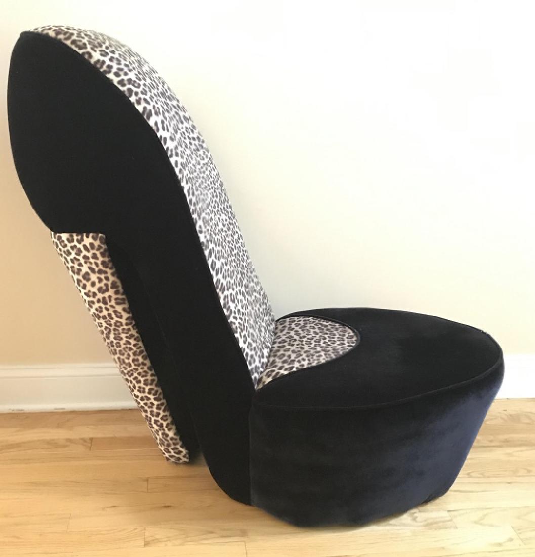 Plush Chair Stylized as High Heel Shoe: Plush chair stylized as high heel shoe, with leopard print and black tone velvet style fabric upholstery. Measures approx 39.5 inches in height by 20.5 inches in width by 44 inches in depth. Some mino