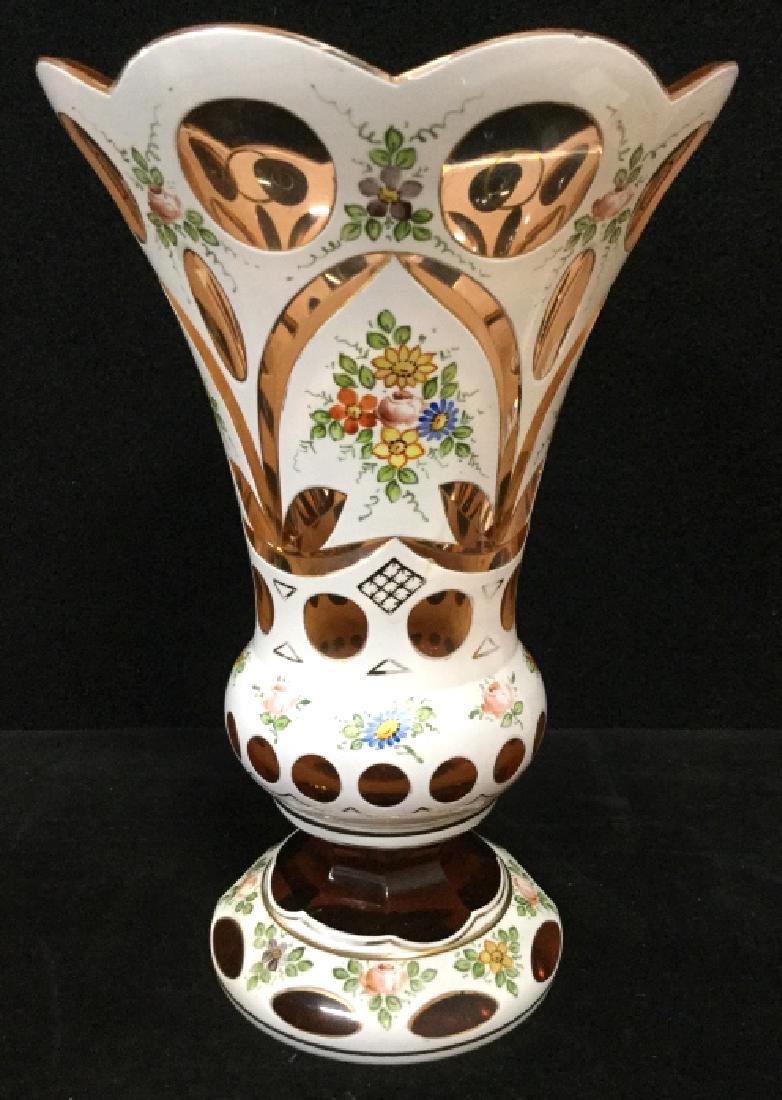 Cut Glass White to Pink Vase: Cut glass vase with painted floral detail, white glass cut to pink. Measures approx 9 in By 6 in. Some surface wear and notable chip to rim and base. Decorative tableware, home decor, vessel, decorati