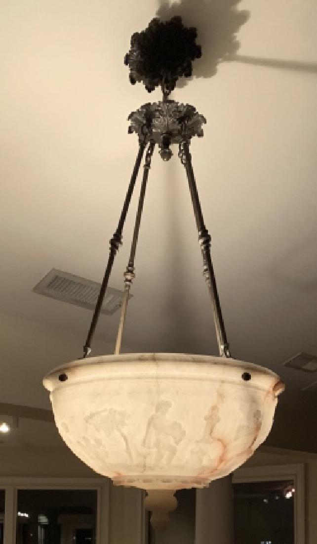 Grand Carved Alabaster Dome Pendant Chandelier: Carved Alabaster Dome pendant chandelier with metal pipe fixture, carved in the round with a figural bacchanal scene. Pendant descends into carved leaf & pineapple bottom finial. Alabaster pendant is 