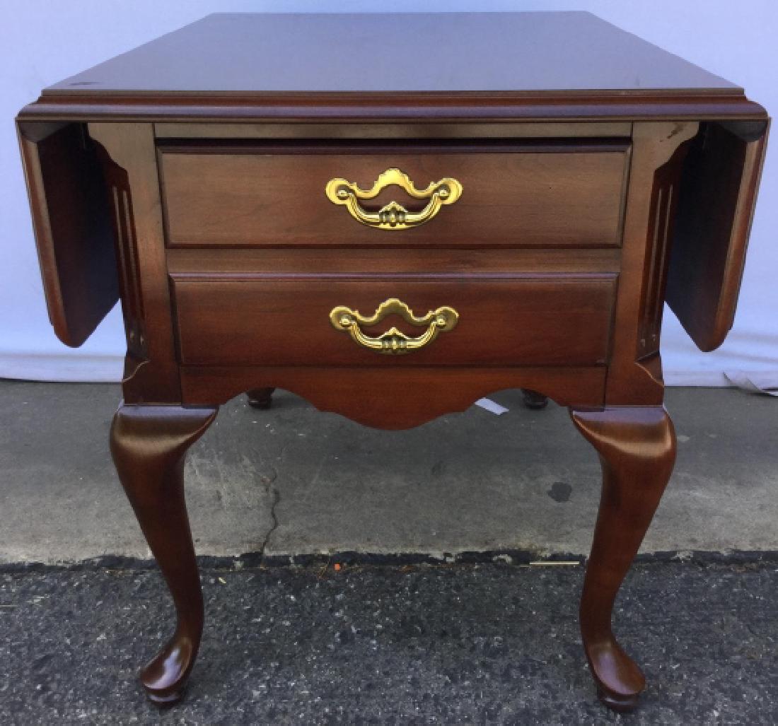 THOMASVILLE Drop Leaf Carved Wooden Side Table: Interior of drawer is marked THOMASVILLE. Piece contains 4 carved wooden cabriole legs. Drawer has 2 gold toned handles. Piece also has 2 drop leafs. Measures approx 38 inches long, 28 inches deep 24