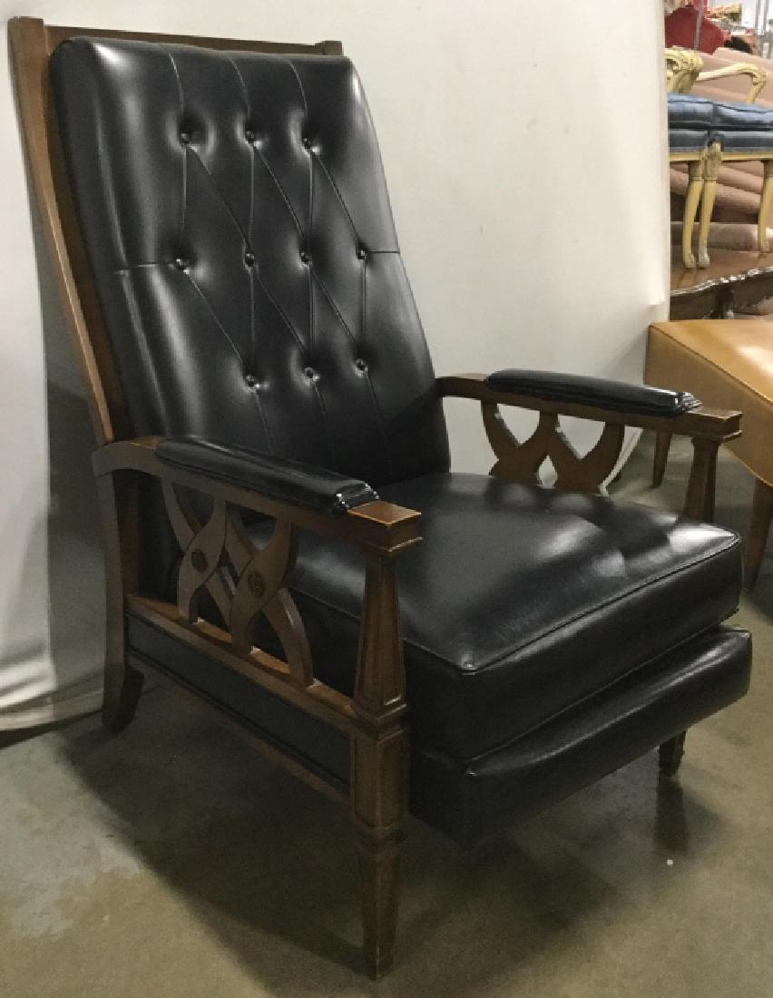 Vintage Black Toned Leather Recliner: Frame of recliner is wooden, backrest, armrest and Seat is black toned, appears to be genuine leather. Measures approx 42 inches tall 26 inches wide 40 inches deep. Backrest is tufted. Contains some w
