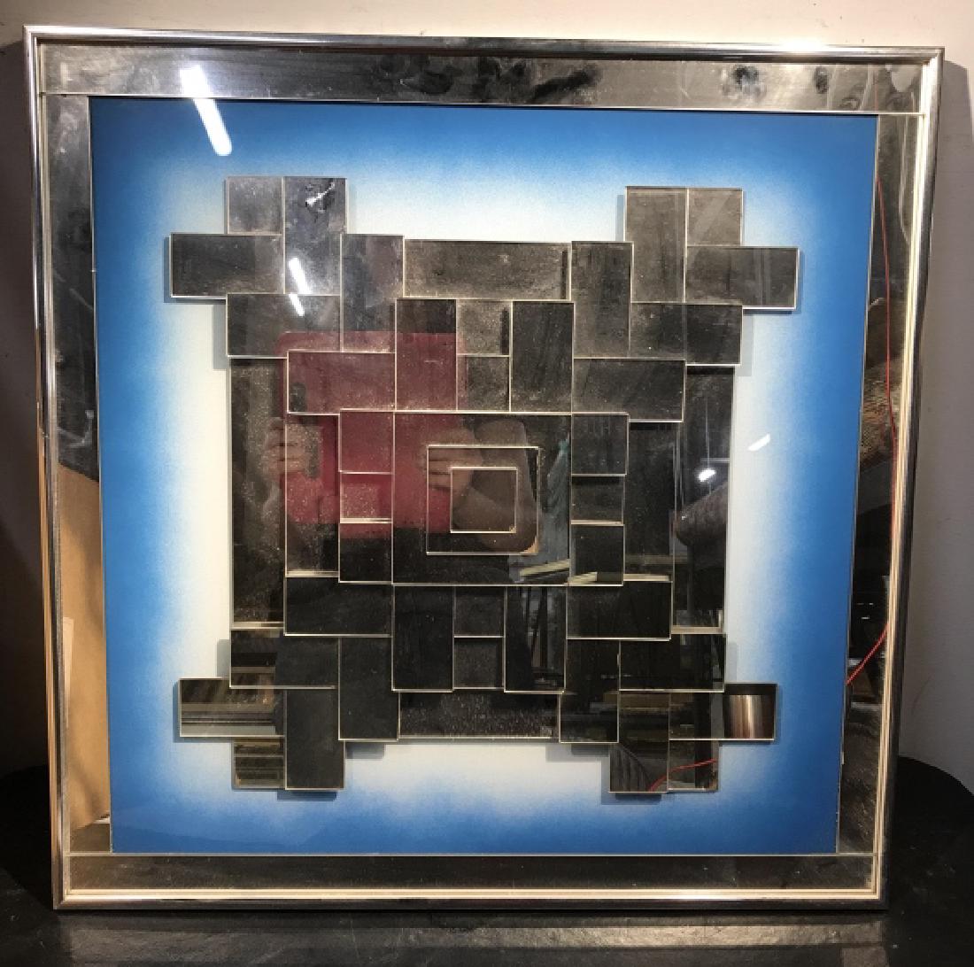 Contemporary Stacked Geometric Mirror Artwork: Mirror pieces are stacked to create geometric design. Mirror pieces are set against spray paint style blue tone background with mirror border. Artwork is set in silver tone metal frame. Measures appro