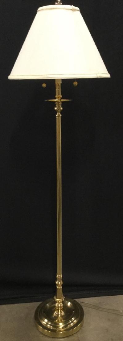 Standing Metal Floor Lamp W Shade: Lamp is gold toned Possibly brass. Shade is cream toned. Contains 2 bulb sockets. Includes finial. Measures approx 57 inches tall 10 inches wide without shade. home lighting, floor lamp, home accent,