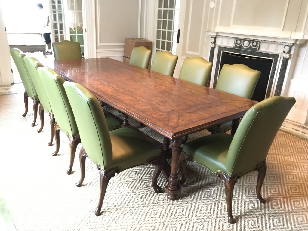 Stately Carved WalnutToned Grand Dining Table: Stately Carved Wooden Walnut Dining Table with turned wooden legs joined by a stretcher, measures without leaves 132 inches long x 53.5 inches wide x 31.5 tall, two extension leaves measure approx 24 