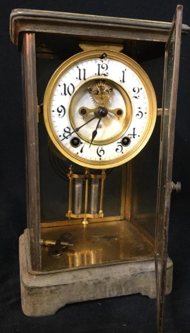 ANSONIA CRYSTAL Regulator Mantel Clock: Backside of piece is marked ANSONIA. Piece is gold toned possibly brass. Piece is vintage. Contains white tonedclock face wit black toned digits. MEASURES approx 11 inches tall 6.5 inches wide, 5 inch