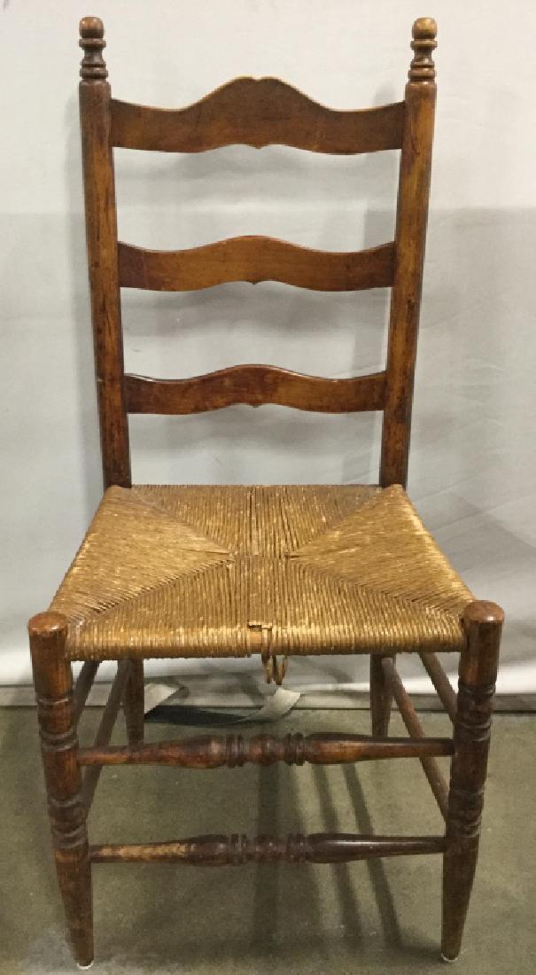 Vintage Carved Wooden Rush Seat Side Chair: Side chair has rush sear & Carved wooden detail. Piece has ladder style backrest. Measures approx 38 inches tall 18 inches wide 16 inches deep. Home furnishings, side chair, dinner chair 6.