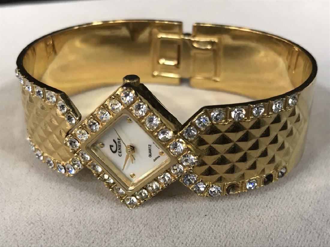 CENERE Gold Toned and Rhinestone Bangle Watch: CENERE Gold Toned and Rhinestone Bangle Watch, 3/4 in square case 2 1/4 in diameter of bangle, Chanel Style Design on band, several rhinestones missing but other wise good condition, Watch, Wristwatch