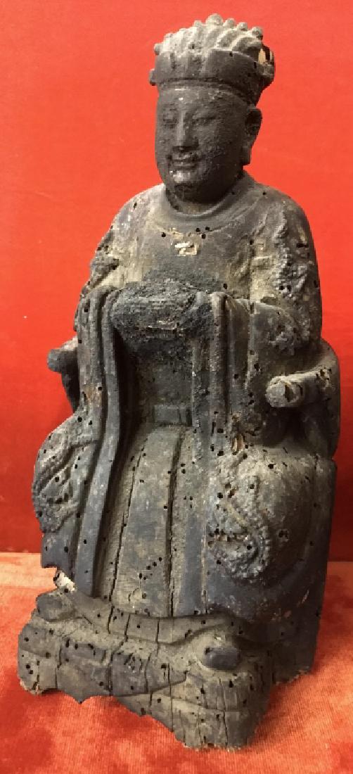 Antique Wood Carved Seated Buddha Figurine: Buddha in robes is seated on chair. Hand carved wooden sculpture. Measures approx 9 inches in height by 4.5 inches in width by 3 inches in depth. Some surface wear like cracking and marks consistent w