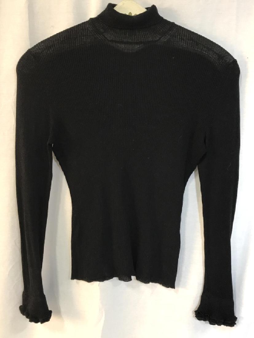 GUCCI Luxury Designer Silk Turtleneck Sweater: Ruffle details on the cuffs. Label reads for GUCCI, Size M, 100% Silk. Sweater is black in tone. Good condition. Luxury Designer fashion, GUCCI fashion garment, cold-weather clothing, designer fashion