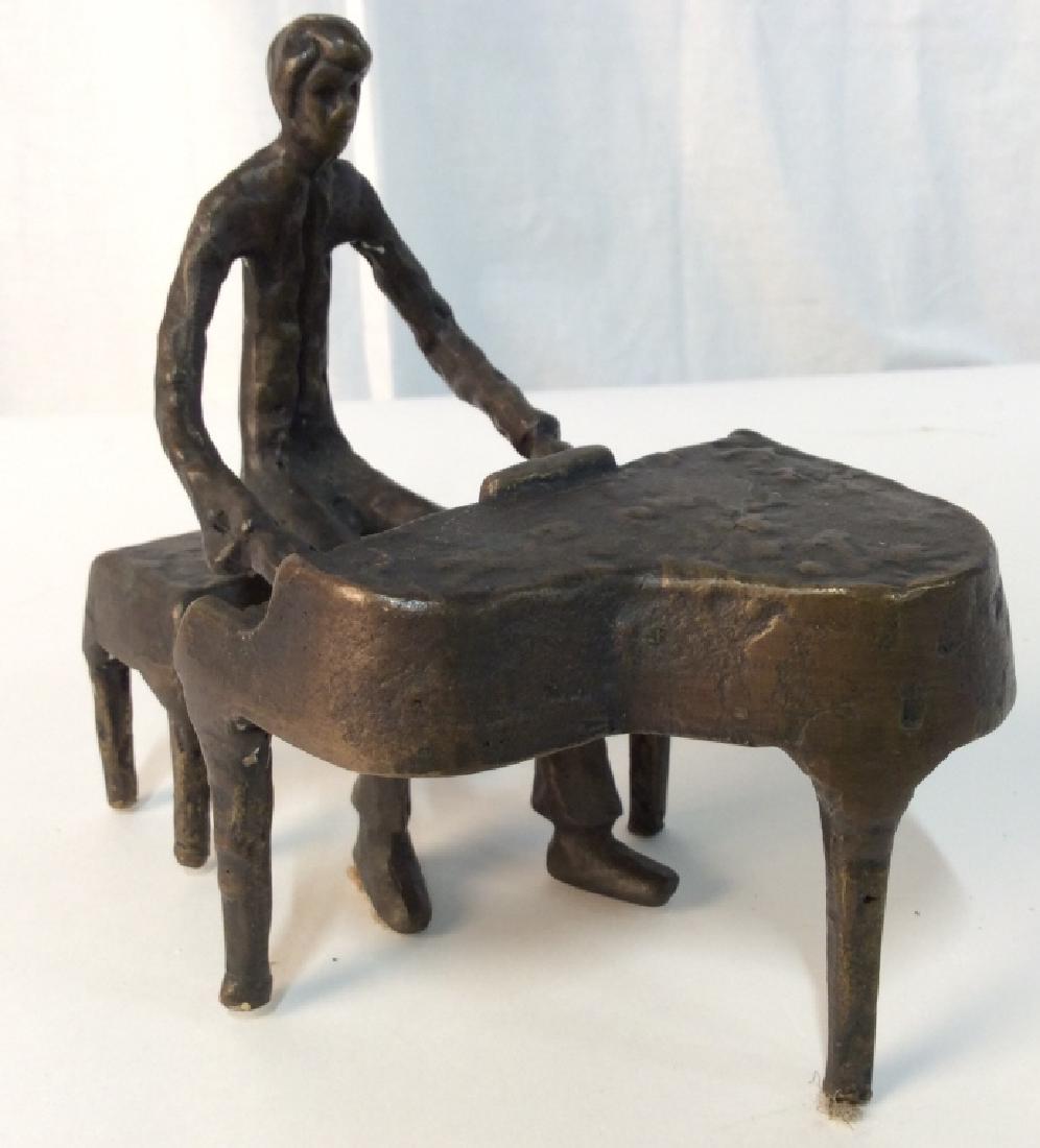Vintage Bronze Male Figure On Piano: Piece appears to be bronze. Depicts a male figure playing piano. Piece is vintage. Measures approx 6 inches tall 7 inches long, 4 inches wide. musician figural, shelf piece, home accent home accessory