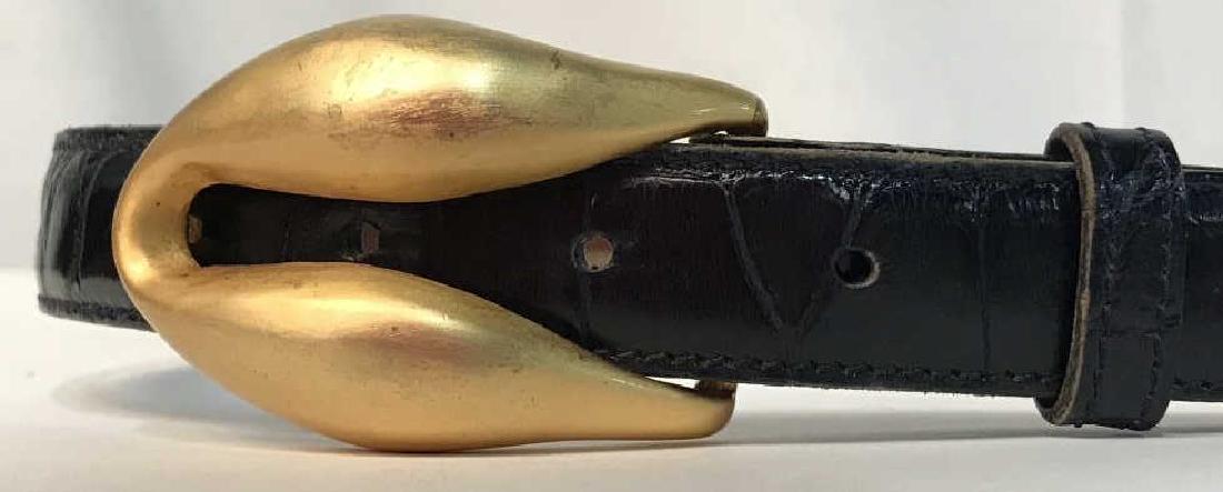 BARRY KIESELSTEIN-CORD Designer Alligator Belt: Genuine alligator skin belt with simple gold tone belt buckle, almost shaped like a fortune cookie. Belt is marked for Barry Kieselstein-Cord, New York, Genuine Alligator, 1. Belt is black in tone. Ho