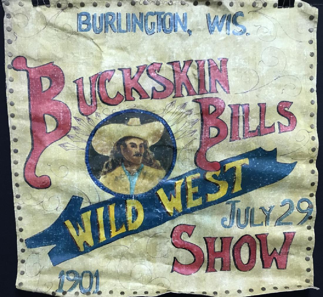 Antique Buckskin Bill’s WILD WEST SHOW Banner: Antique hand-painted banner advertisement for Buckskin Bill’s WILD WEST SHOW in Burlington, Wisconsin in 1901. Painted banner is on loose canvas with brass tack trim. Banner features portrait of man