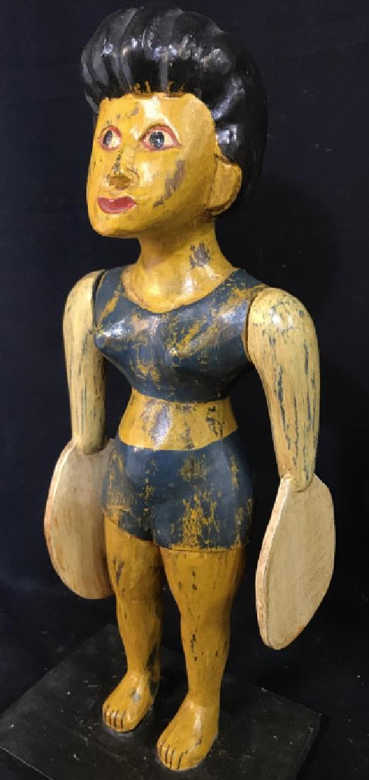 Vintage Folk Art Whirligig Style Figurine Of Woman: Vintage folk art carved and painted Figure Of a woman with articulated arms ending in paddle-like hands. Figure is reminiscent of a whirligig, but arms do not spin freely. Measures approx 16.5 inches 