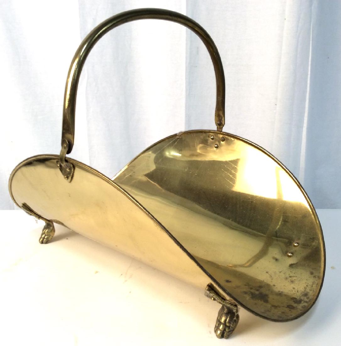 Gold Toned Footed Brass Firewood Holder: Firewood holder is gold toned and brass. Contains 4 gold toned feet. Piece is handled. Measures approx 16 inches tall 21.5 inches long, 13.5 inches deep. Piece has some wear. Firewood holder, brass fi