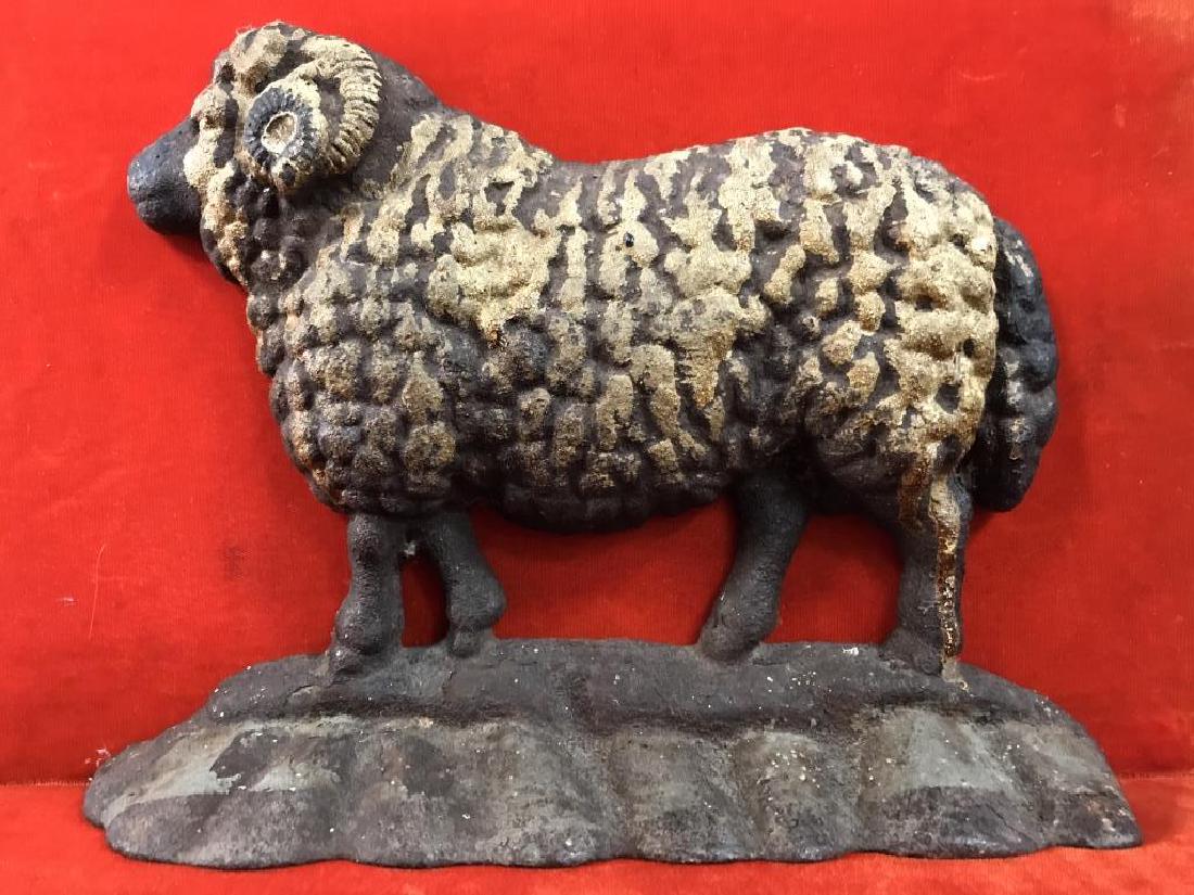 Cast Iron Doorstop Stylized as a Ram: Early 20th Century cast Iron doorstop Stylized as ram. Measures approx 7 inches in height by 9.5 inches in width by 2 inches in depth. Doorstop has surface wear consistent with age, including fading o