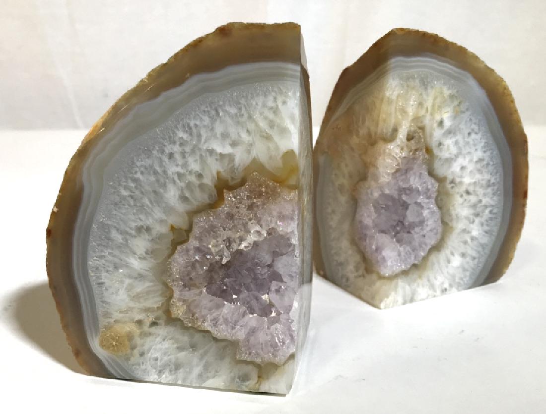 Pair of Amethyst Geode Book Stoppers: Two piece Amethyst book stopper set. Natural, rough, outer layer with violet, gold, and clear crystals on the inside. Measures 4.5 in tall and 3.5 in wide (each). Crystals, stones, gemstones, book sto