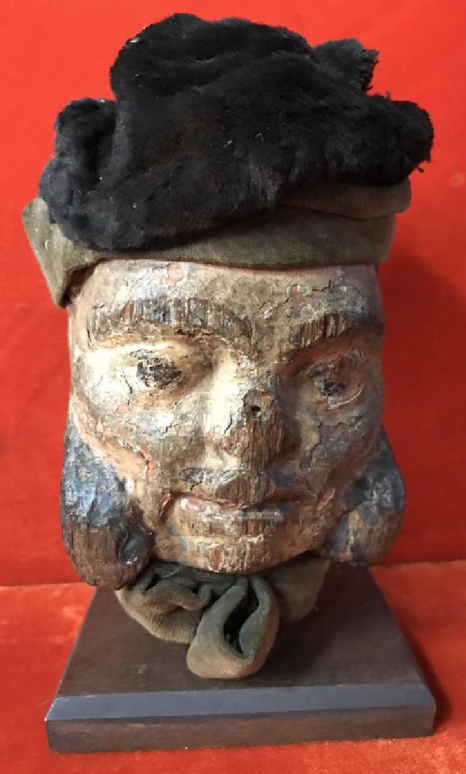 Early 18th Century Antique Wood Carved Puppet Head: Early 18th Century Antique Wood Carved puppet head with mixed fabric hat and scarf, possibly velvet-like fabric. Puppet head is painted and is attached to wood base. Measures approx 7 inches in height