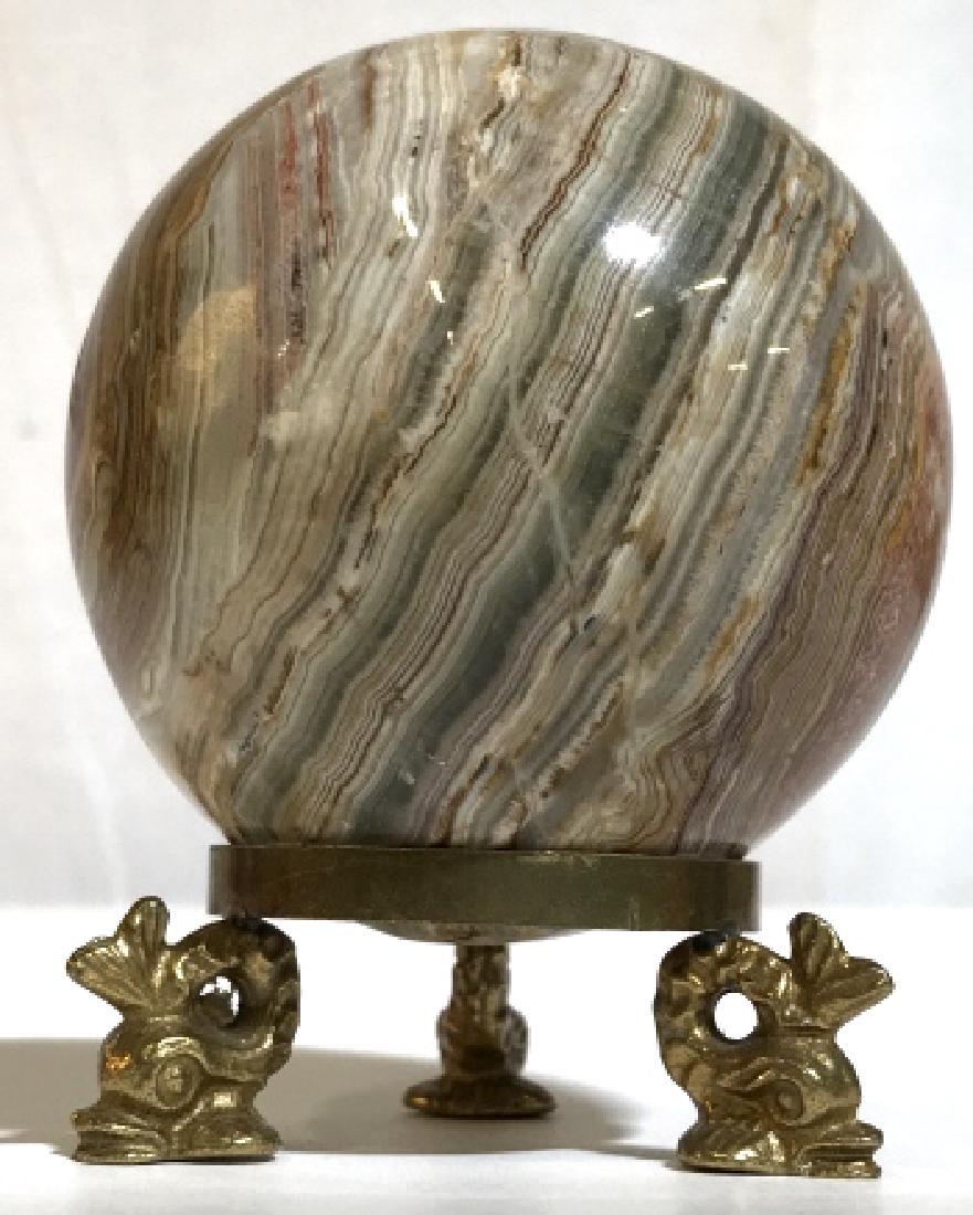 Decorative Vintage Table Topper Accessory: Spherical Decorative Stone Vintage Table Topper Accessory With Brownish Earth Toned Natural striations and stripes, Held by a Vintage Brass Colored Metal footed piece. Measures approximately 3.8 in ta