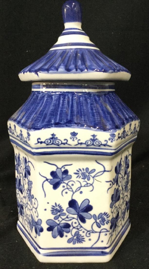 Blue & White Toned Asian Style Lidded Urn: Urn is blue and white toned with floral, leaf and vine detail. Piece includes lid. Rim of piece has chip. Measures approx 12 inches tall 7 inches wide. Ginger jar, lidded vessel, home accent, shelf pi