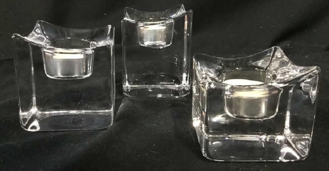 Lot 3 ORREFORS Cut Crystal Candle Holders: Lot includes 3 Cut Crystal Candle Holders. Each are marked ORREFORS on underside. All Candle Holders are different sizes. Largest measures approx 4 inches tall 3 inches wide. Luxury designer home acce
