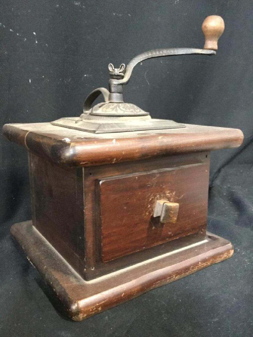 Americana Pine Coffee Grinder W Drawer: Poss Cast Iron Top Crank, vintage Coffee Grinder Cabinet. Piece has crank on top. Crank is metal and wooden. Piece has small wooden drawer area. Measures approx 20.5 inches wide and deep 14inches tall