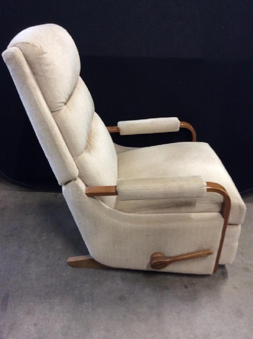 Mid Century Modern Style Recliner: Recliner has mid Century Modern Style. Piece Is tan toned with light brown toned wooden frame. Piece measures approx 39 inches tall 27 inches wide, 35 inches deep. MCM, mid century modern furnishings,