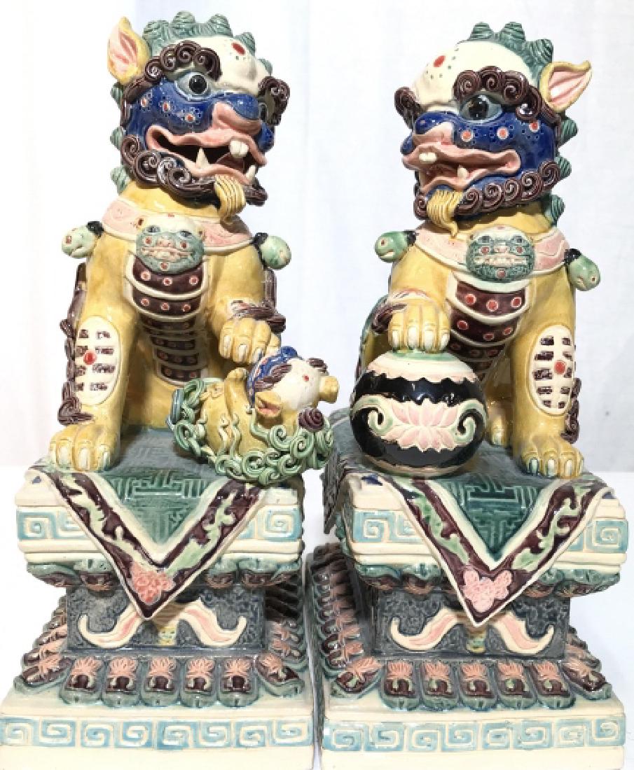 Pair Signed Chinese Porcelain Foo Dogs: Painted porcelain foo dogs, Temple Lions, guardian dogs Chinese Dragons,Asian Decorative Arts, Orientalism, orientalia, raises signature on underside in Asian characters, good condition, each measures