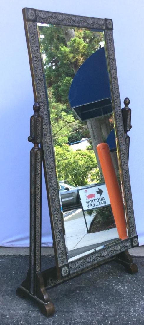 HOWARD ELLIOTT Full Length Cheval Mirror: Rectangular Mirror is beveled and is set in dark tone wood frame with floral relief pattern. Marked on verso for Howard Elliott Collection. Measures approx 67.5 inches in height by 33 inches in width