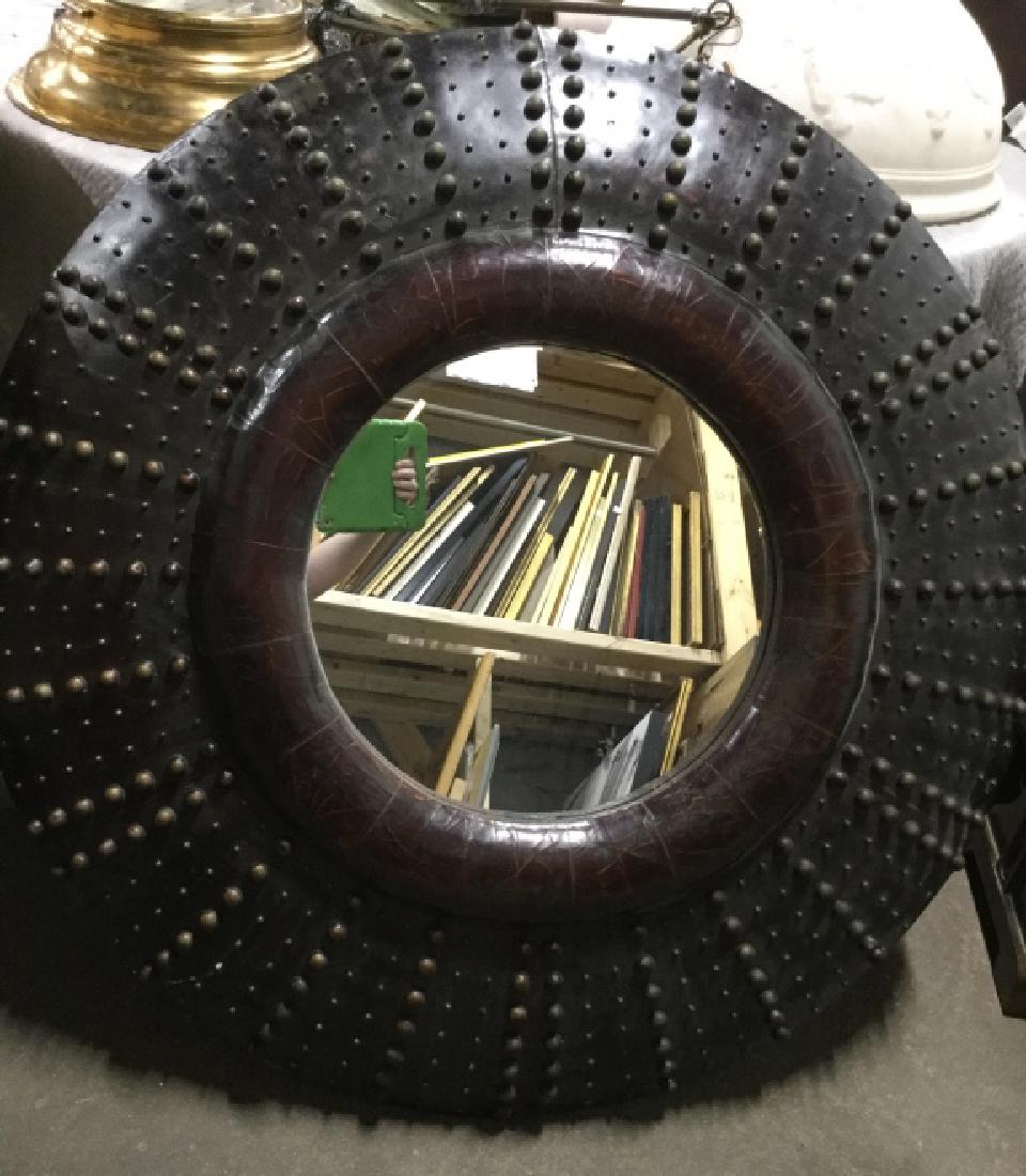 Oversized Antique Mirror in Leather Frame: Antique Circular mirror is set in convex circular frame with leather finish and tacked ball textured pattern. Measures approx 44 inches in diameter by 4 inches in depth. Some ball tacks appear to be m