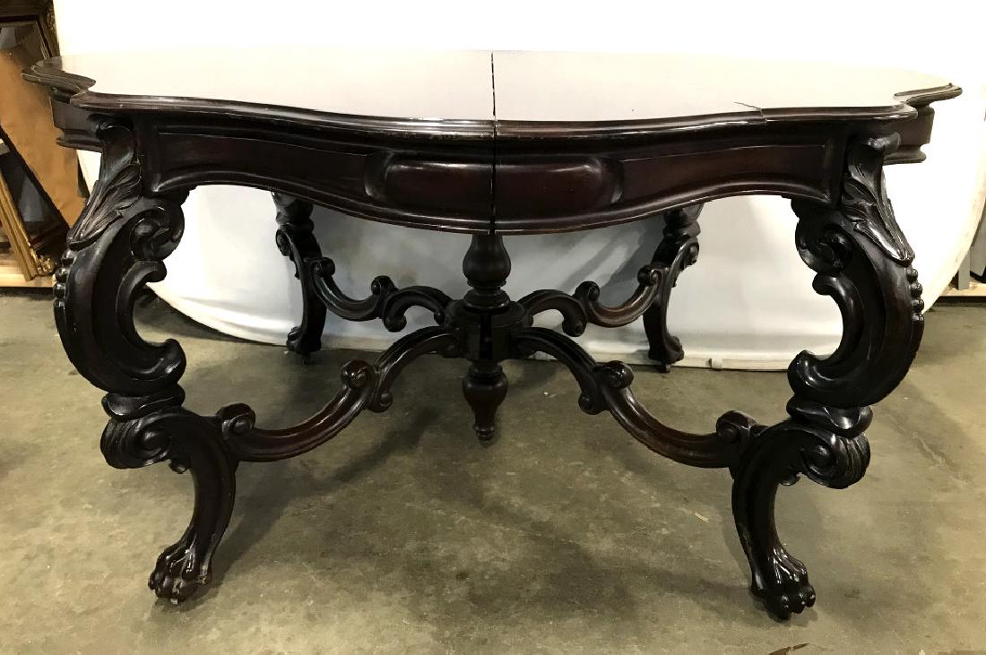 Antique Ornate Wood Dining Table W Lion Paw Feet: Richly carved antique dining table with lions paw feet. Tabletop has oval style shape and is extendable. Includes 2 leaves for extension, along with felt tabletop protector panels. Measures approx 31 