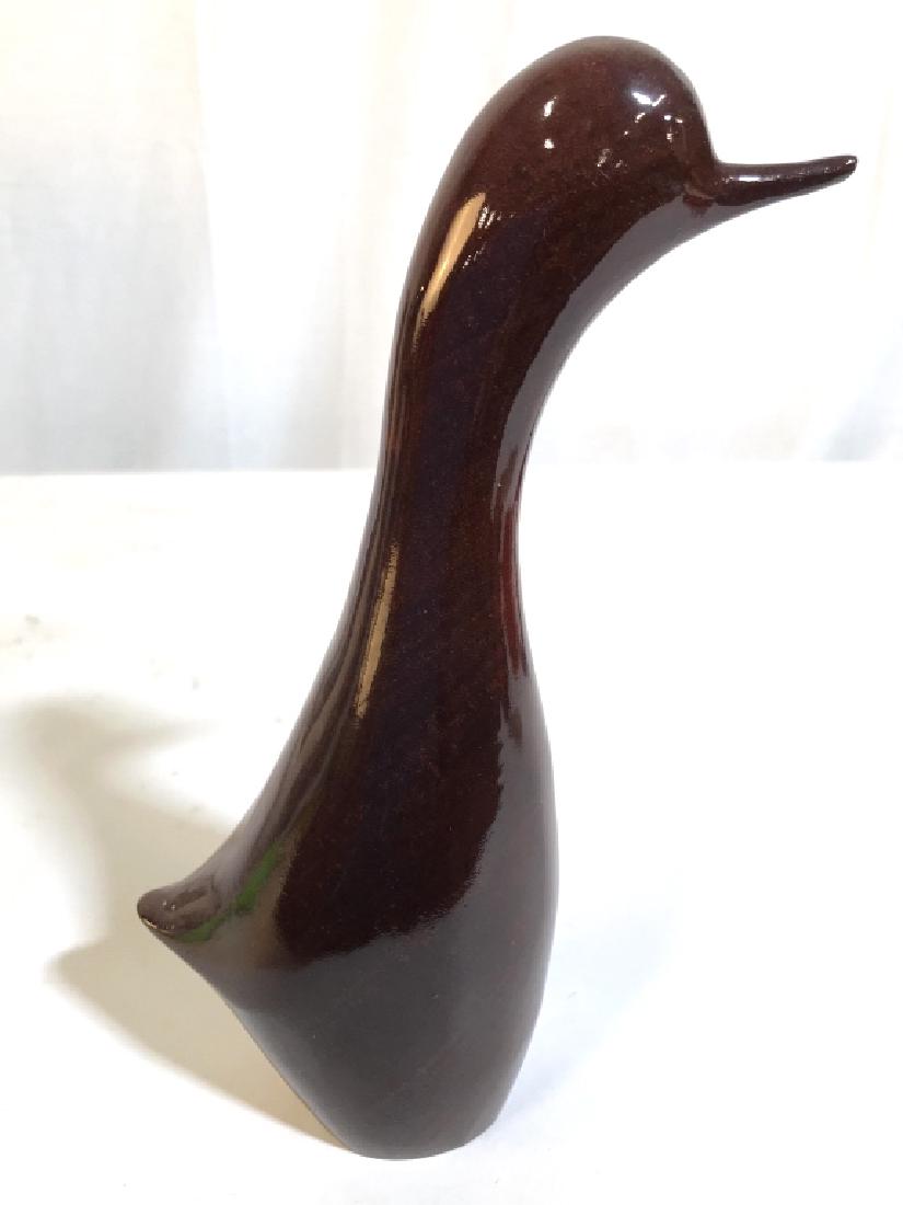 Carved Wooden Bird Figural: Piece appears to possibly be hand carved. Figural resembles a bird, piece is brown toned. Measures approx 9 inches tall 4 inches deep. Minimalist design, smooth lines, statuette, bird figural, decor p