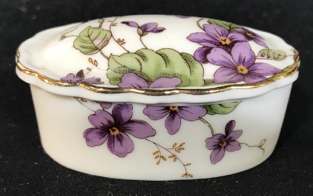 Lot 3 LEFTON CHINA Floral Detailed Pill Boxes: Underside of each reads LEFTON CHINA. Lot includes 3 porcelain Trinket Boxes. Each are floral Detailed. Each measures approx 2.75 inches long, 1.75 inches deep, 1.25 inches tall. Trinket boxes, vanity