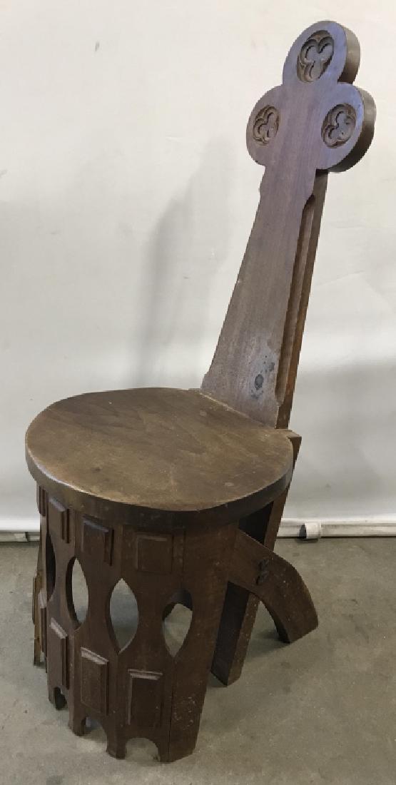 Primitive Wood Spinning Chair W Trefoil Design: Primitive antique style wooden spinning chair with trefoil design back. Verso is stamped ‘Made in Spain.’ Measures approx 38.5 inches in height by 16.25 inches in width by 15 inches in depth. Ther