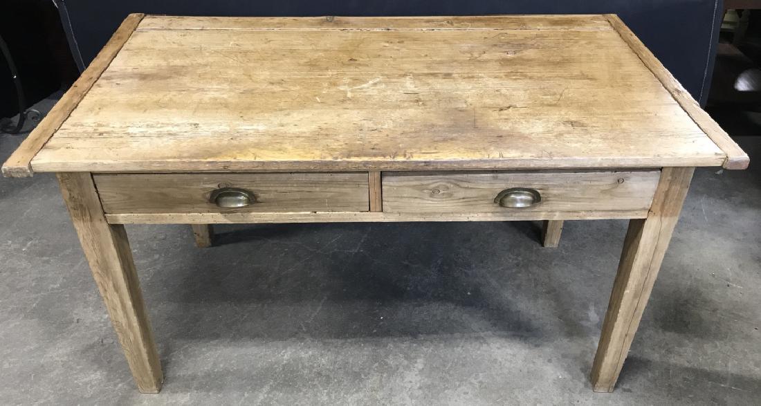 AntiqueStyle Scrubbed Pine Farmhouse Kitchen Table: Pine kitchen table with two drawers with brass handles. Sits on tapered supporting legs. Possibly antique. Measures approx 31.25 inches in height by 56 inches in width by 30.5 inches in depth. Some su