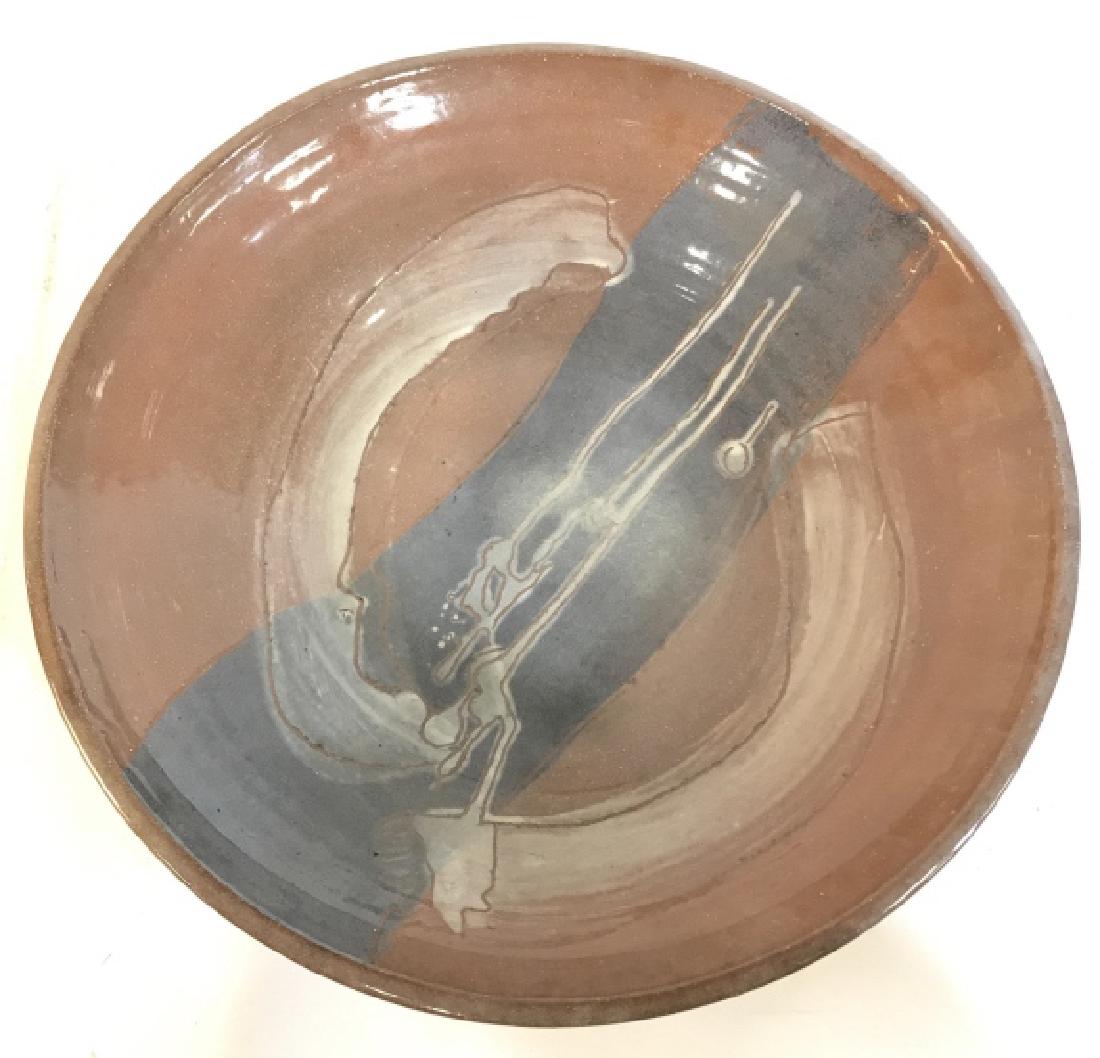 SYLVIA Signed Ceramic Centerpiece Bowl: Underside of piece is signed SYLVIA. Piece is ceramic. Contains tones of light brown & slate. Measures approx 16 inches wide 4 inches tall. Centerpiece fruit bowl, decorative tableware, earthenware, c