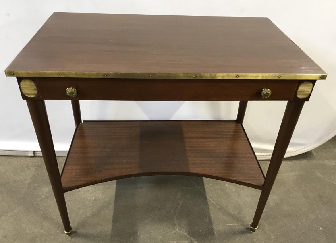 Wooden Side Table W Brass Details: Side table has frieze drawer with brass handles. Lower concave line shelf. Brass banding around surface. Measures approx 28.5 inches in height by 32.35 inches in width by 19.25 inches in depth. Some m