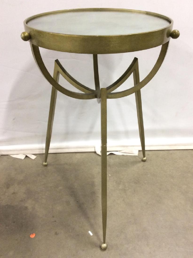 Vintage Gold Toned 3 Leg Metal Table: Table top has mirrored surface. Table top has circular shape. Piece contains 3 legs, each leg has spherical shape at ends. Measures approx 26 inches tall 20 inches wide at base. Contains some scratche