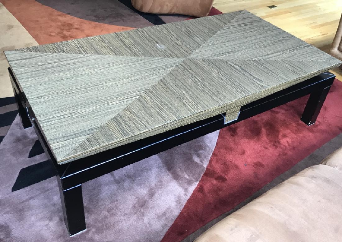 Contemporary Lacquered Coffee Table: Lacquered Contemporary coffee table. Top section is in lacquered striped Wood Pattern, bottom section is black tone coated wood material. Measures approx 17,75 inches in height by 62.25 inches in leng