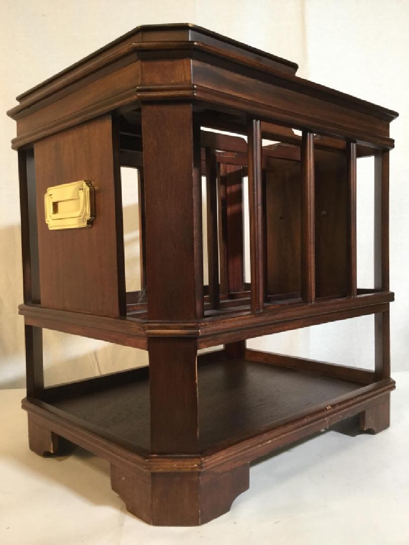 Carved Wooden Canterbury: Canterbury is brown toned and wooden. Contains removable sliding top. Piece has 2 gold toned metal handles. Measures approx 20 inches tall and long, 15.5 inches deep. magazine bin, home accent, home d