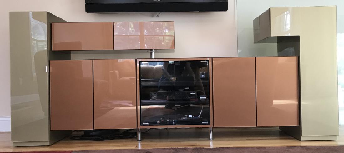 Unique 4-Piece Glossy Two-Tone Media Console: Console is beige and rust red in tone, with glossy clear coating. Console has multiple drawers and shelves. Measures approx 90 inches in width, 37.5 inches in height by 17.5 inches in depth. Some ligh
