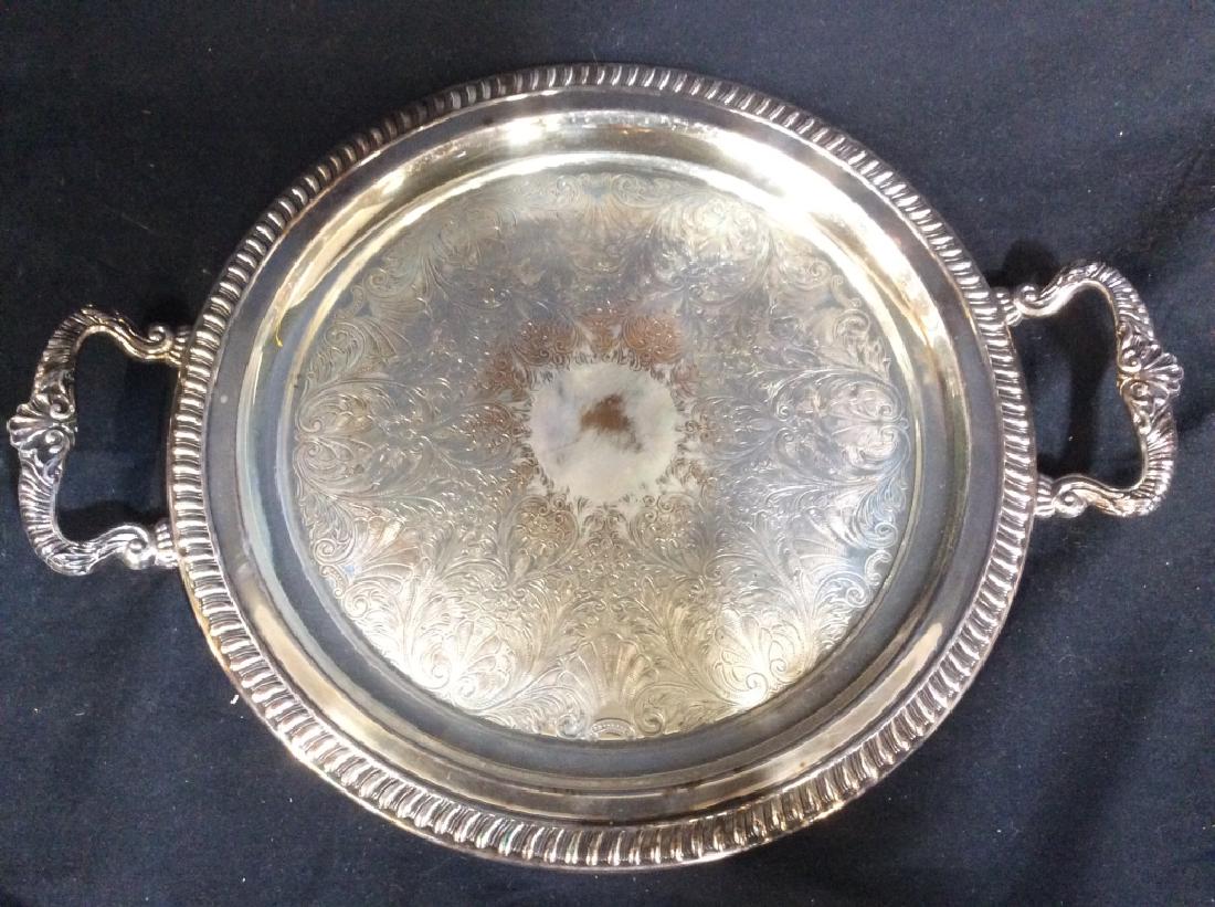 Silver On Copper Handled Serving Plate: Underside is marked SILVER ON COPPER. Piece has Handle on each side. Contains ornate detail in center. Measures approx 17 inches wide. Tabletop decor, Tabletop Accessories, Serving Plate, Serving Plat
