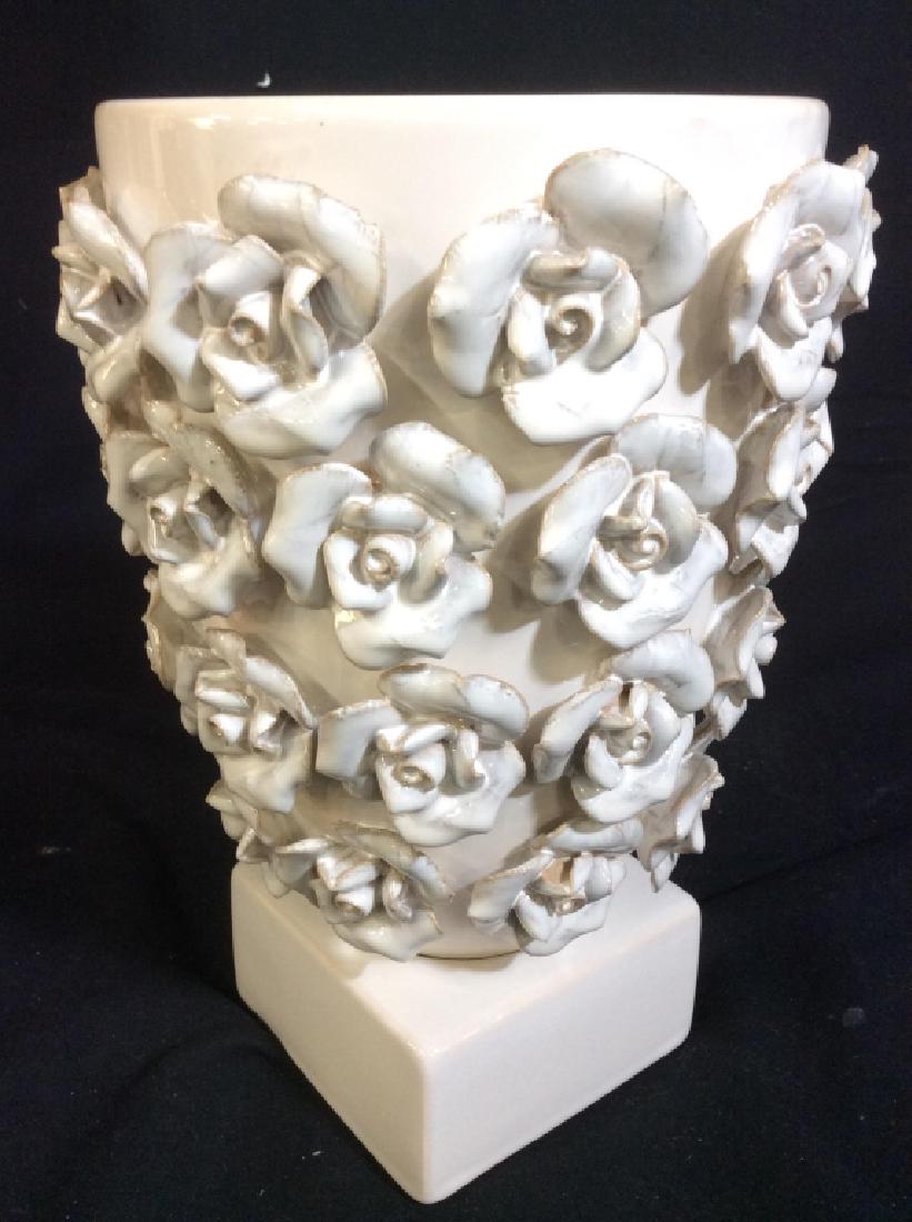 ABIGAILS Floral Detailed Porcelain Vase: Underside is marked ABIGAILS. Vase is white toned with floral detail. Base is cube shaped, measures approx 10 inches tall 7 inches wide. Porcelain vase, floral vase. tableware, tabletop decor and coll