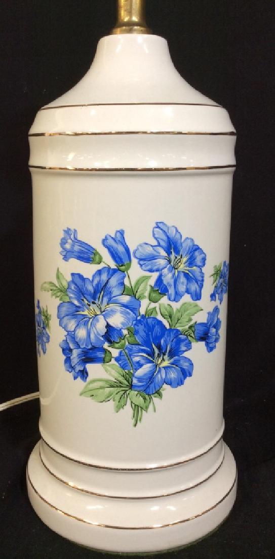 Floral Detailed Porcelain Lamp: Lamp is porcelain. Contains blue and green toned floral detail. Measures approx 24 inches tall 6 inches wide. home lighting, home decor, home accessories 6