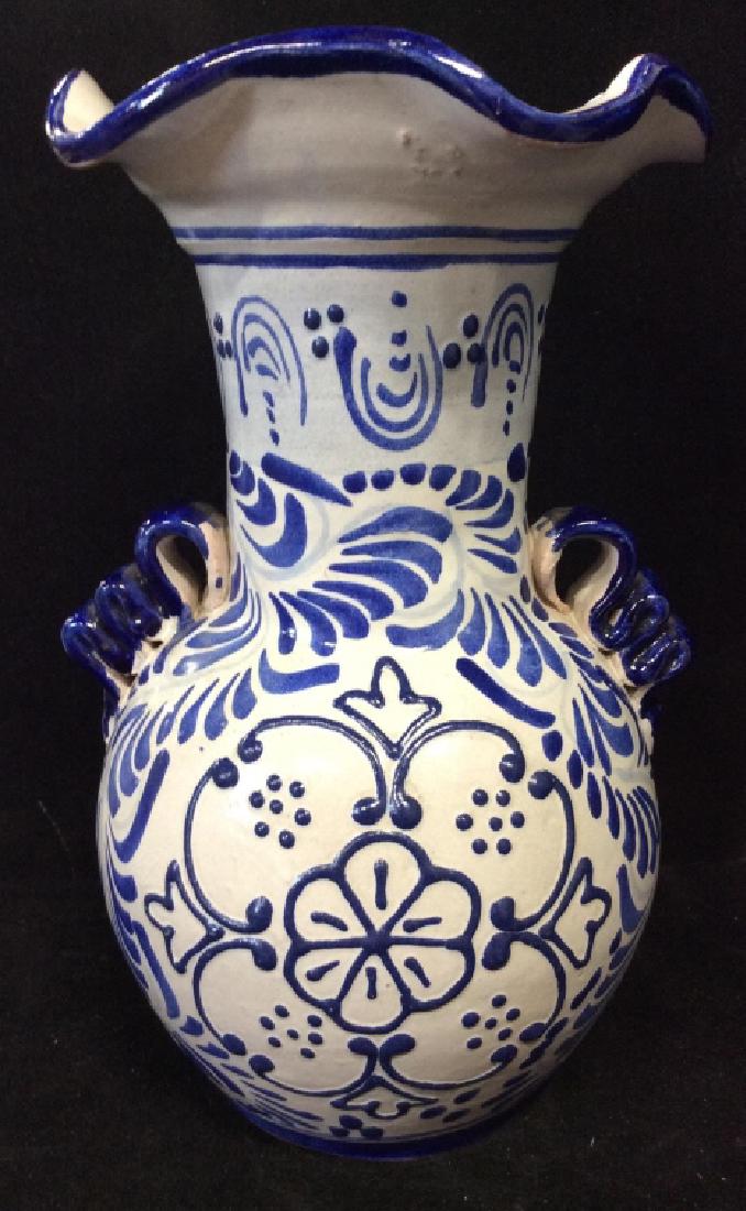 ALBA TALAVERA Hand Painted Pottery Vase, Mexico: Signed on underside as Alba Mexico, tag reads Alba Talevera Hand Painted by Mexican hand crafters. Unique Blue and white ceramic pottery vase with curled handles, shaped rim and floral design. Some su